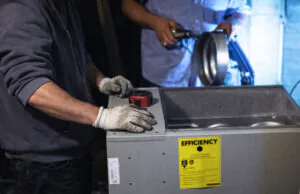 HVAC technicians replacing furnace.